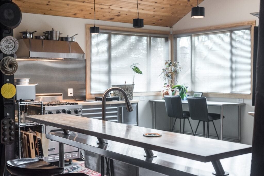 A well-equipped kitchen with a sink, stove, and refrigerator, highlighting essential appliances for meal preparation.